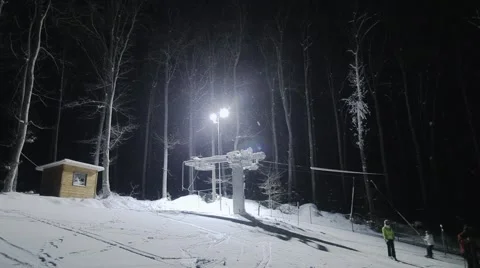 Ski elevator and people skiing at night Stock Footage 46034401