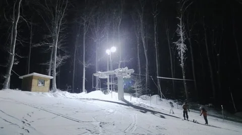 Ski elevator and people skiing at night Stock Footage 46034415