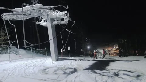 Ski elevator and people skiing at night Stock Footage 46034447