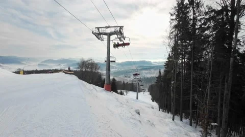 A ski elevator with people in the background of the mountains and a picturesq Stock Footage 219003964