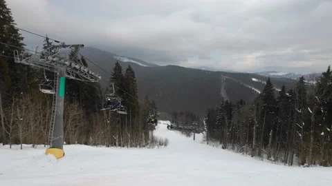 A ski elevator takes people up the mountain at a ski resort. Stock Footage 219002742