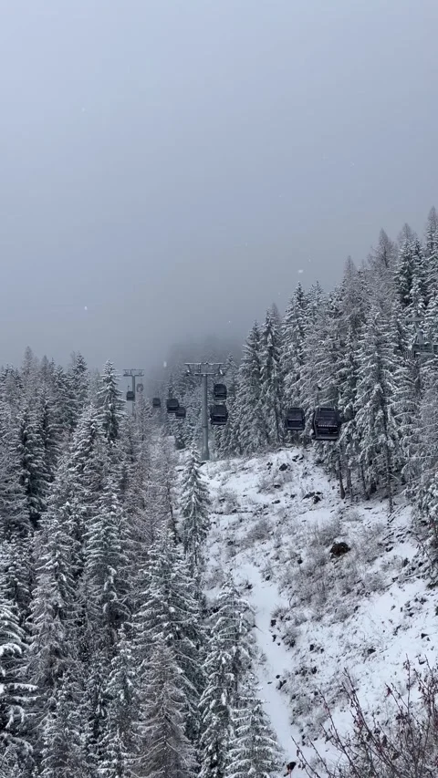 Ski gondolas of Courchevel ski resort in French alps on a snowy day Stock Footage 337093896