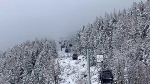 Ski gondolas of Courchevel ski resort in French alps on a snowy day Stock Footage 337094844