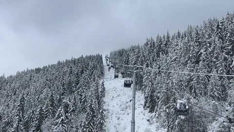 Ski gondolas of Courchevel ski resort in French alps on a snowy day Stock Footage 337233930