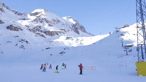 Ski instructor guiding children downhill skiing Stock Footage 293556834