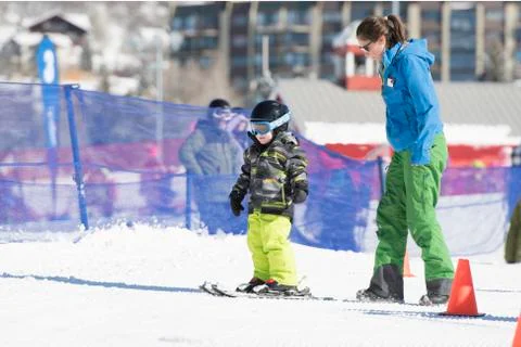Ski Instructor Teaching a 3-Year Old Toddler Boy at a Mountain Resort Stock Photos