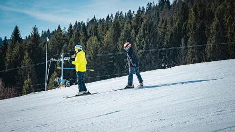 Ski instructor teaching a boy during a sunny day Stock Photos