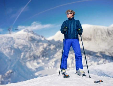 Ski instructor young man on the top of snow hill Stock Photos