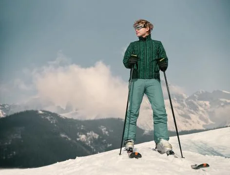 Ski instructor young man on the top of snow hill Stock Photos