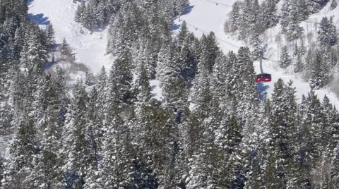 Ski Lift Elevates Over Snow Covered Mountainside by Aerial Drone Stock Footage 64823052