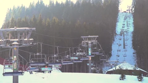 Ski lift elevator transporting skiers and snowboarders Video stock 200785328