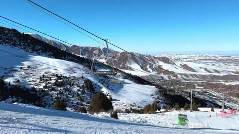 Ski lift in motion. Empty cable car on mountain slope at ski resort Stock Footage 299618607
