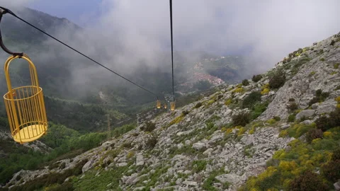 Ski lift to the mountain. View of the moving cabins at a height. Stock Footage 329560102