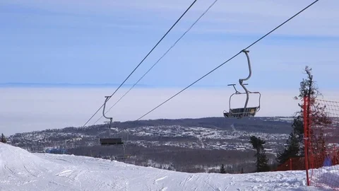Ski lift moving up to the mountain. Video stock 74190459