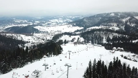 Ski lift with seats going over the mountain and paths from skies and snowboar Stock-Footage 121372853