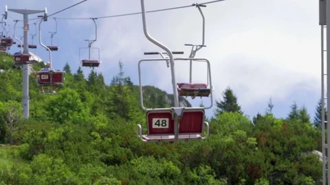 Ski lift taking tourists on top of Velika planina mountain in Slovenia Stock Footage