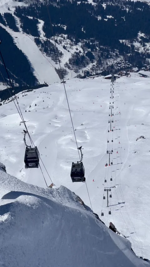 Ski lifts between Courchevel ski resort and Meribel ski resort in Trois valley Stock Footage 334442637