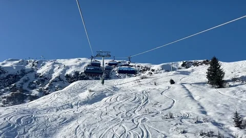 Ski lifts going up and down in Meribel ski resort, French alps, France Stock Footage 334405411