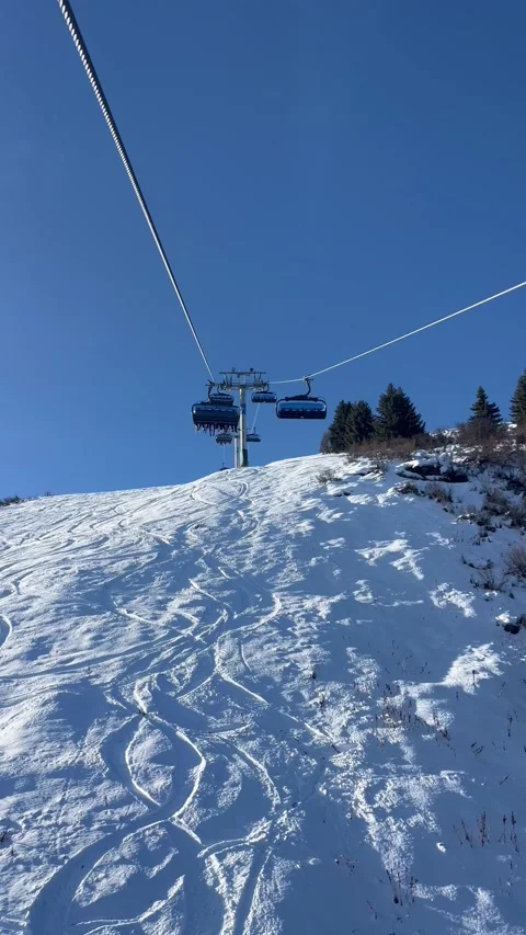 Ski lifts going up and down in Meribel ski resort, French alps, France Stock Footage 334405420