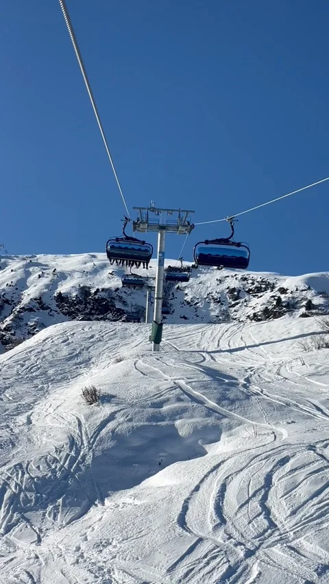 Ski lifts going up and down in Meribel ski resort, French alps, France Stock Footage 334405461