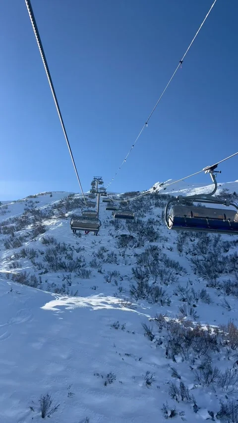 Ski lifts going up and down in Meribel ski resort, French alps, France Stock Footage 334405470