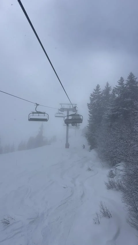 Ski lifts going up and down in Courchevel ski resort over snow mountains Stock Footage 334420195