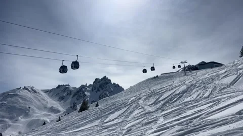 Ski lifts going up and down in Courchevel ski resort over snow mountains Stock Footage 334440233