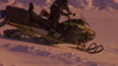 Ski Patrol Worker Rides Snowmobile Across Alpine Slope Stock Footage 346326148