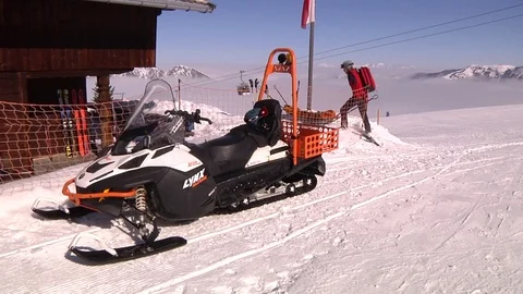 SKI PATROLLER WITH SKIDOO Stock Footage 121444703