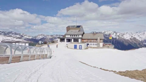 Ski resort building on mountain top with melting snow 스톡 동영상 310164012