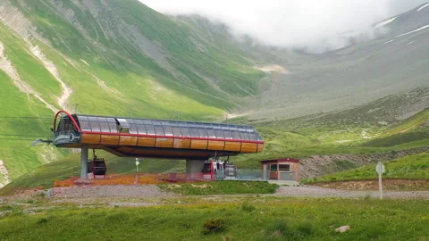 Ski Resort Cableway Elevator Station on Green Mountains Fog Background Stock Footage 255311776