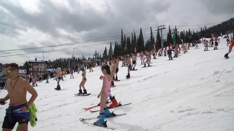 Ski resort. Descent from mountain in bathing suits "E" Stock Footage 88764122