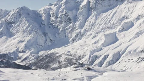 Ski resort in a massive mountain valley in Italian alps, aerial view Stock Footage 262994003