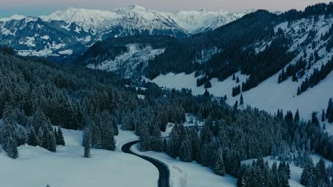 Ski Resort Road Winding Through Snowy Mountain Landscape with Pine Trees Stock Footage 331167292