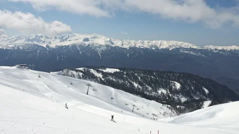 Ski resort with slope and cable cars among sunny mountains Stock Footage 252059667