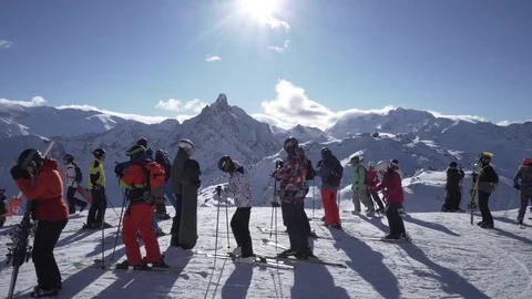 Ski resort on top of mountain A group of skiers prepare for the descent. Action Stock Footage 84845313