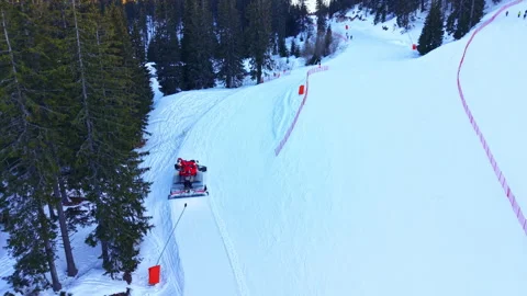 Ski resort workers grooming the snow on slopes in winter with a snowcat vehicle Stock Footage 336495819