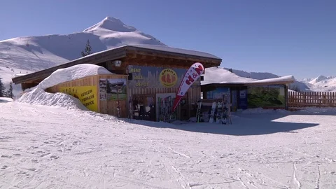 SKI SHOP WITH MOUNTAIN BACKGROUND Stock Footage 121444537