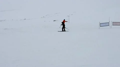 Ski slope in fog. Cloudy, poor visibility. Skiers in bad weather. Mountain sk Stock Footage 201892329