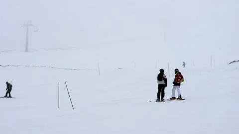 Ski slope in fog. Cloudy, poor visibility. Skiers in bad weather. Mountain sk Stock Footage 201892333