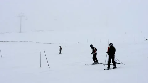 Ski slope in fog. Cloudy, poor visibility. Skiers in bad weather. Mountain ski Stock Footage 201892335