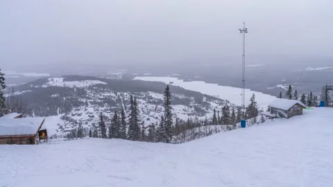 Ski Slope Timelapse and Snowcapped Summit and Woodlands wintertime Video stock 237022629
