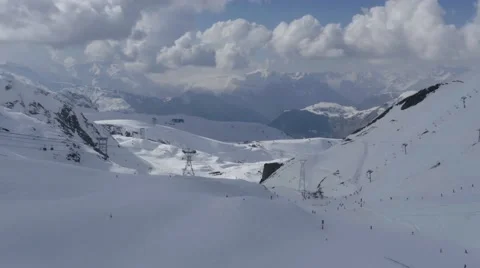Ski slopes arranged in high mountains with grows cliffs where plenty of athle Stock Footage 68944911
