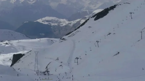 Ski slopes arranged in high mountains with grows cliffs where plenty of athle Stock Footage 68944925