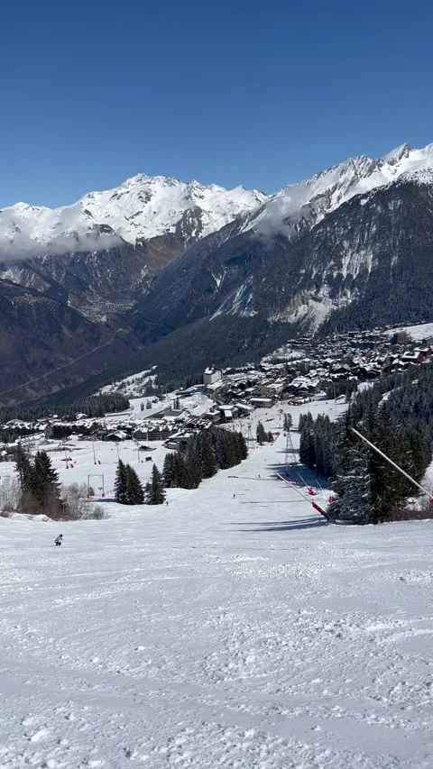 Ski slopes over the Courchevel ski resort town Stock Footage 337093216