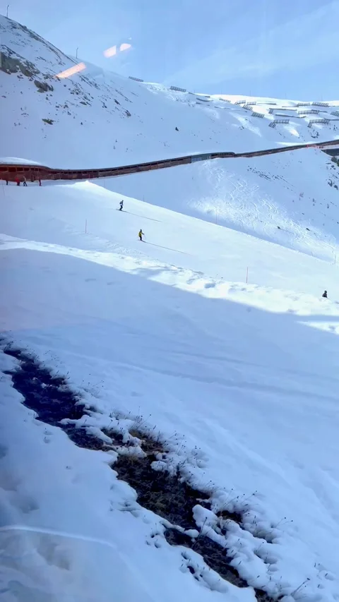 Ski slopes on the train route to Zermatt. 스톡 동영상 214545127