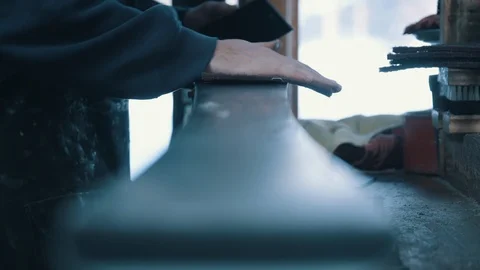 Ski tech buffing base of snow ski in resort shop Stock-Footage 94191556