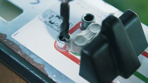 Ski technician drilling binding holes on snow ski Stock Footage 96521059