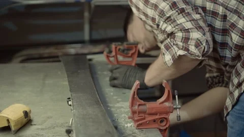 Ski technician is working on fixing and preparing for the season pair of Stock Footage 155352179