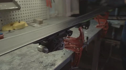 Ski technician is working on fixing and preparing for the season pair of Stock Footage 155352480